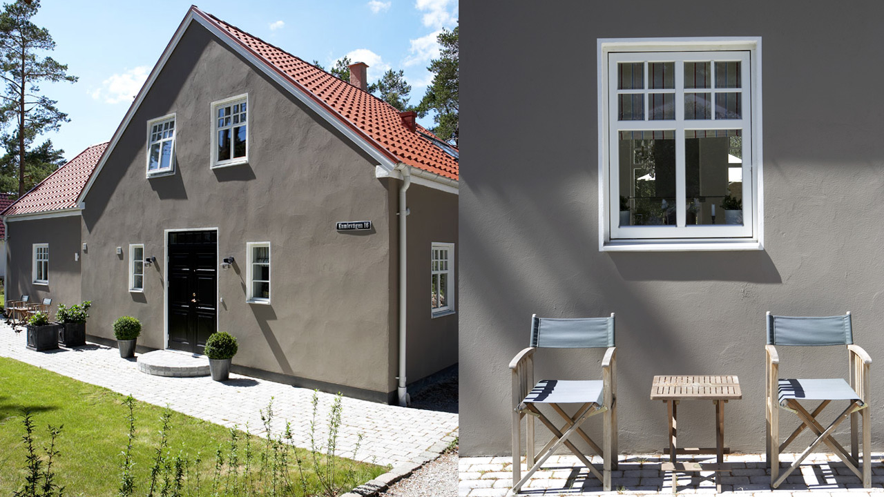 Gråbrunt murhus Gråbrunt nymalt murhus i grønne omgivelser passer fargemessig perfekt sammen